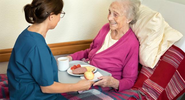 Caregiver assisting senior during in-home care visit in Austin Texas